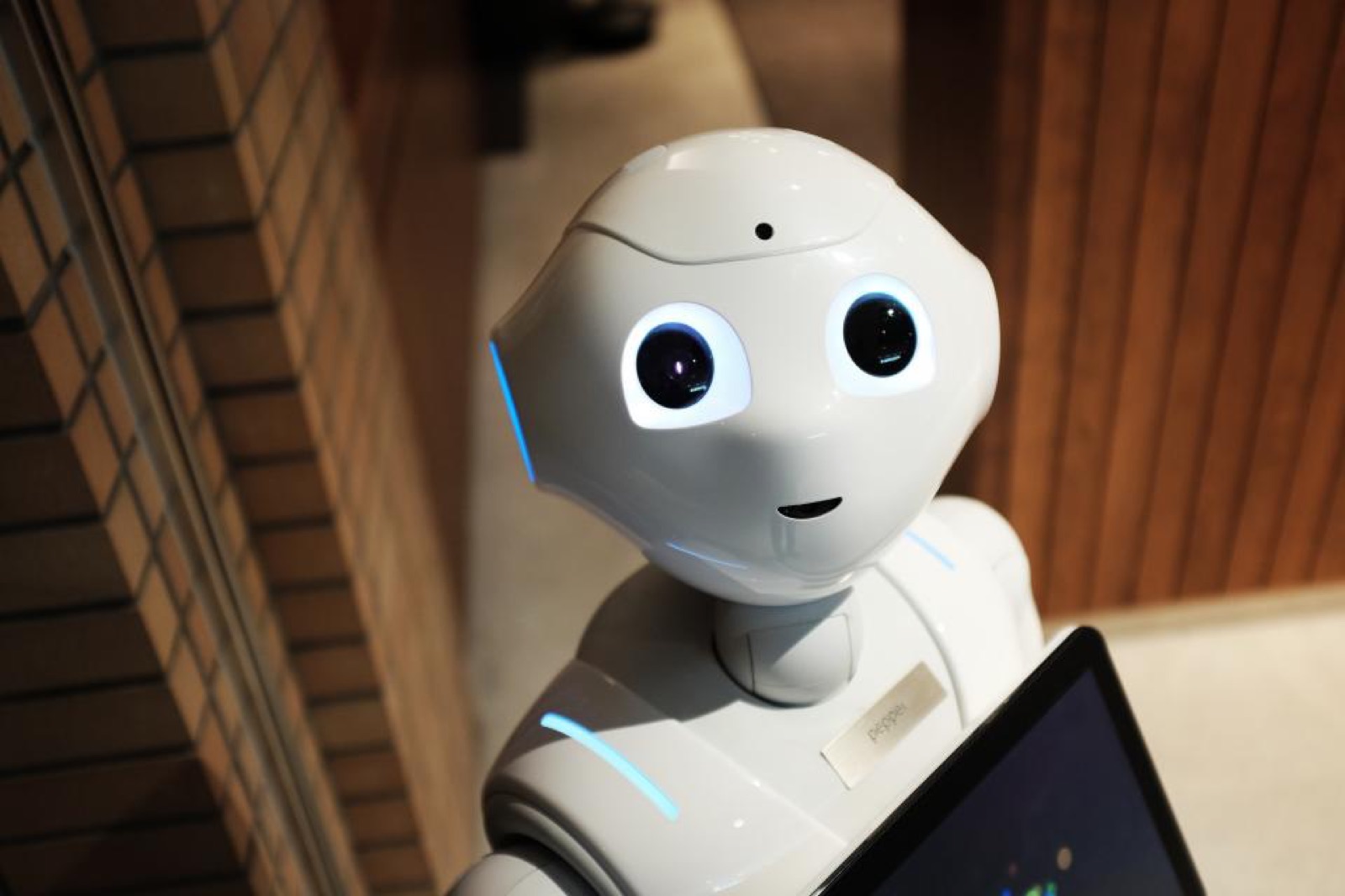 A humanoid robot holding a tablet