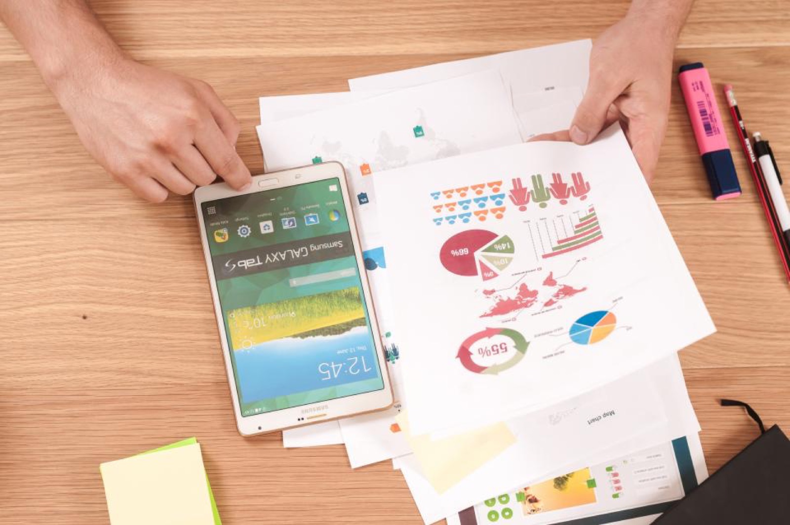 Printed charts and a tablet on a desk