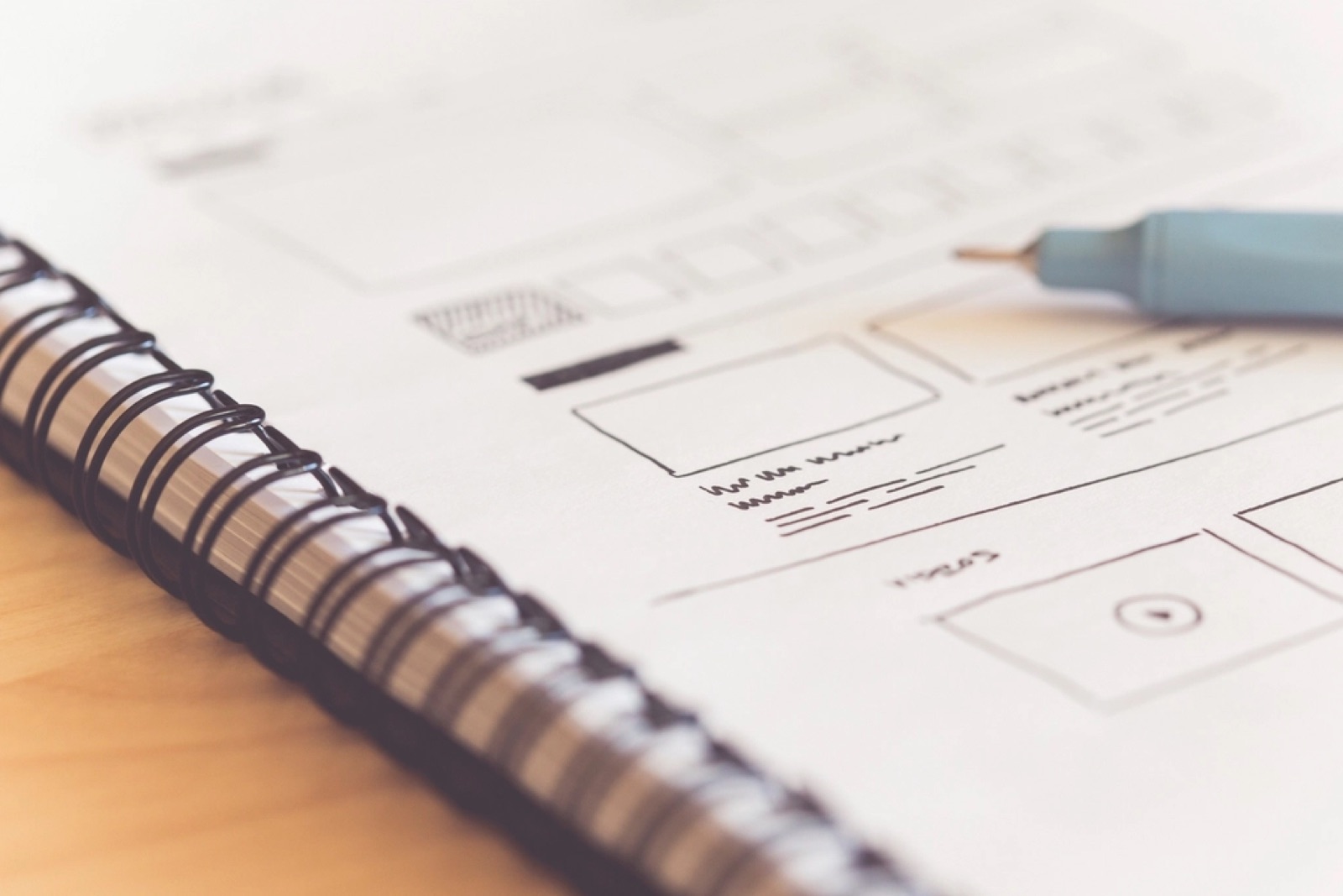 Hand-drawn website wireframe in a notebook